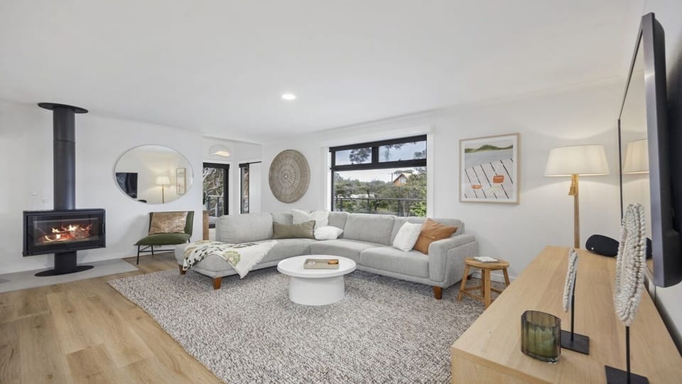 Spacious living room with wood burning fire place 