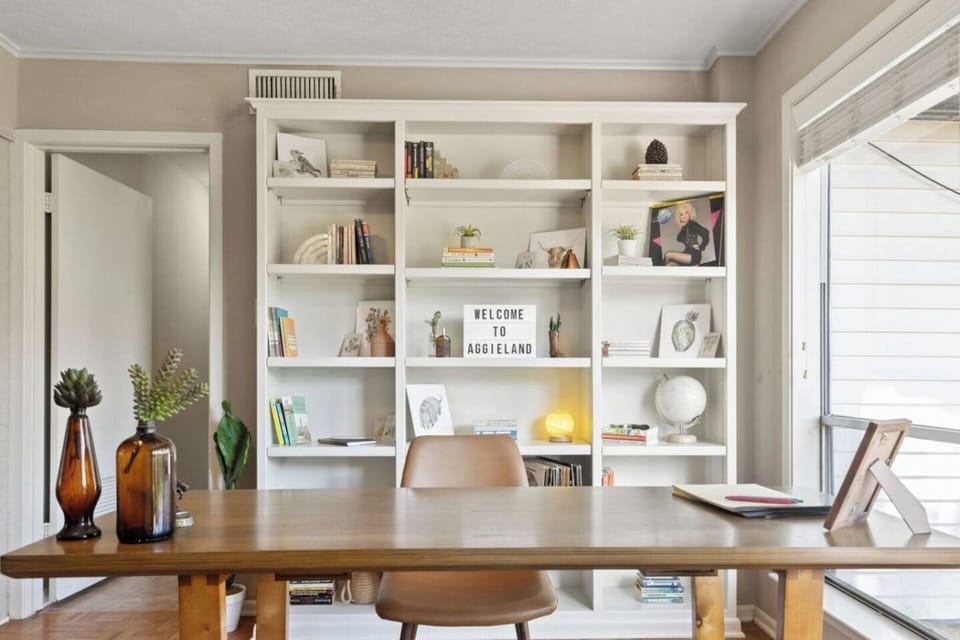 Settle in by the window, open your laptop, and enjoy a quiet moment of focus in this light-filled workspace.
