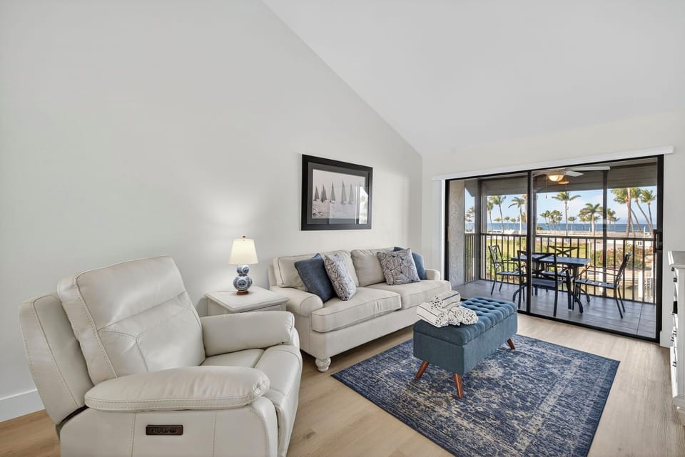 Bright, open-concept living area with beautiful views of the marina and the Gulf.