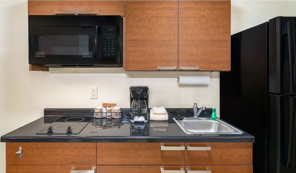 Brew coffee and prep snacks on sleek, clean counters.