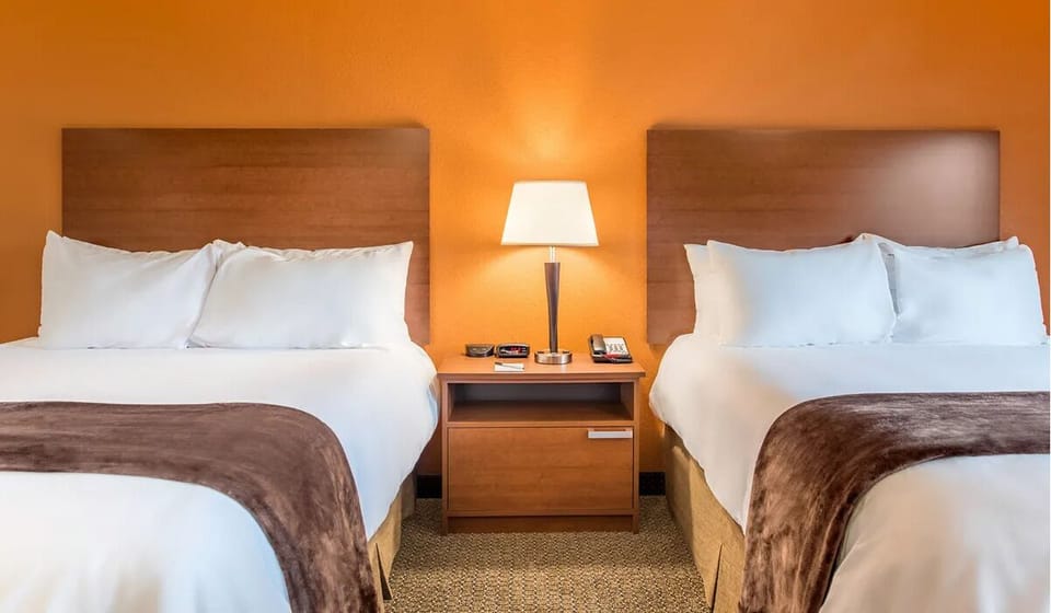 Drift off on cloud-like pillows between warm bedside lighting.