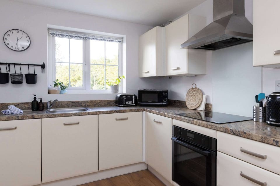 The bright kitchen has everything you need to cook meals and prepare picnics.