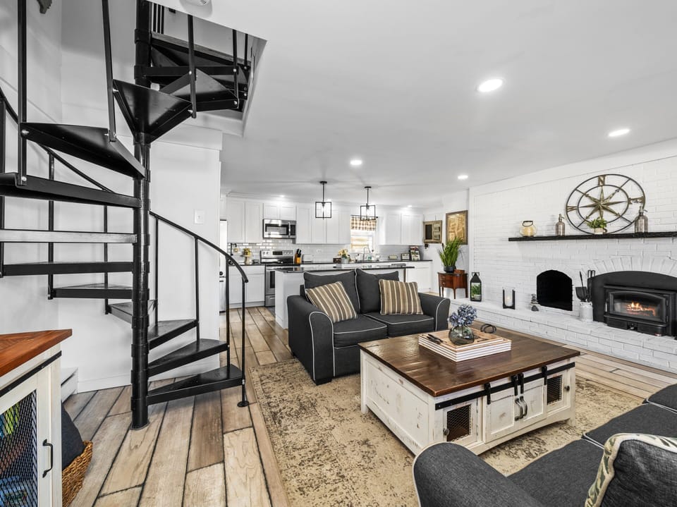 Charming spiral staircase connects living room to bedrooms