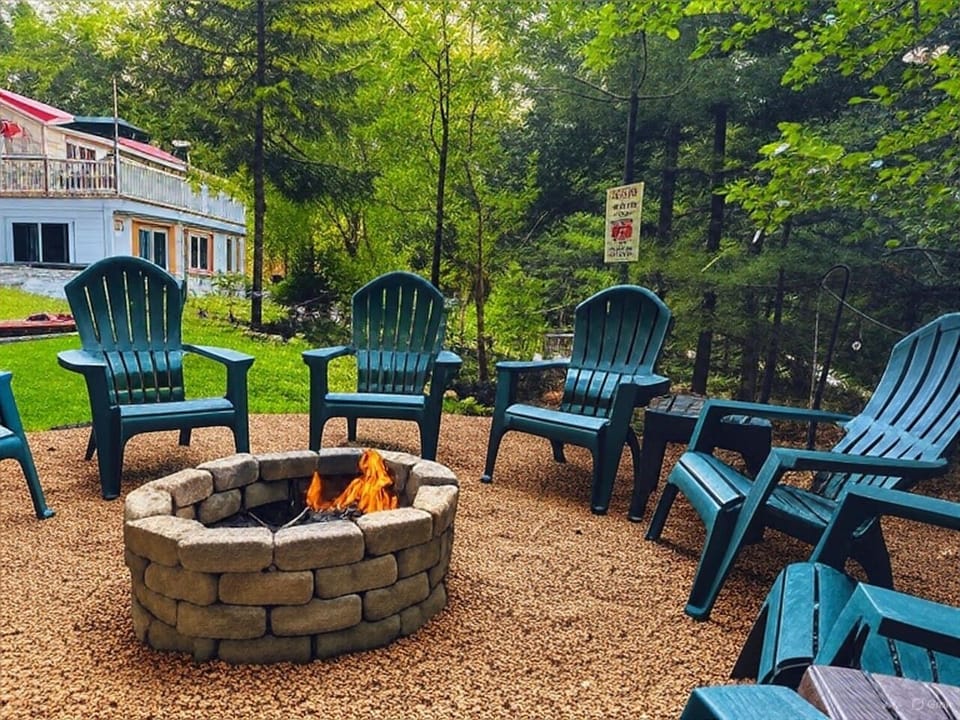 Cozy outdoor firepit area with ample seating—perfect for gathering under the stars, sharing stories, and roasting marshmallows with family and friends. Relax and unwind in true Mountain style!