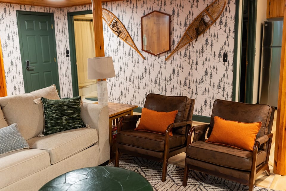 Cozy and inviting! The main living room has a comfy couch, chairs and smart TV, plus a relaxing gas fireplace seating area—just flip the switch and unwind. Perfect for movie nights or morning