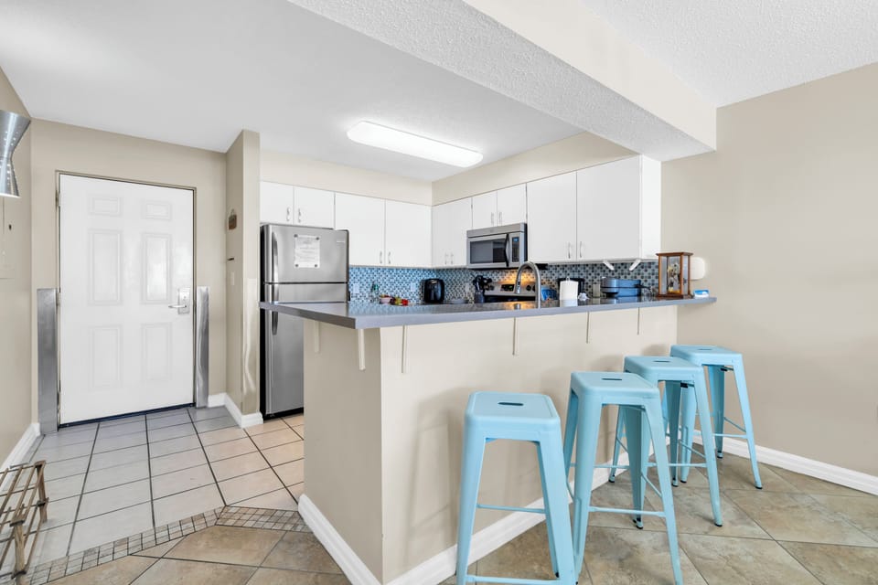 Your bright kitchen features stainless steel appliances and a convenient breakfast bar where you can enjoy morning coffee or casual meals.