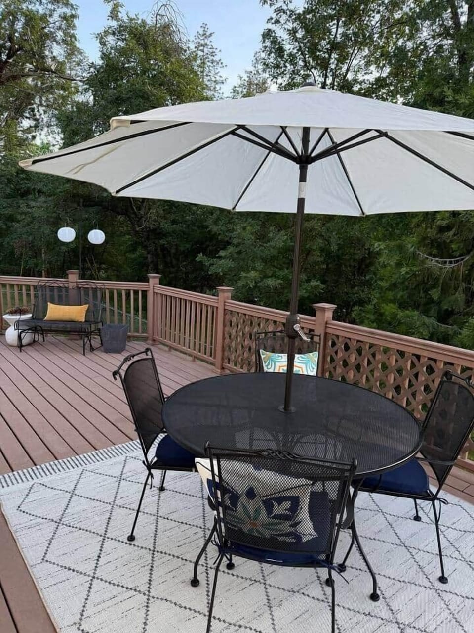 Spacious deck includes high end BBQ, large round tables, smaller square table, 6 chairs, and a rocking bench for lounging. The large deck overlooks the trees and is ideal for watching local wildlife passing by. 