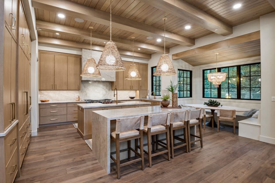 A huge chef's kitchen is well stocked with premium appliances and supplies, two kitchen islands, a built in dining area with beautiful alpine views.