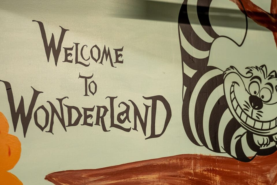 The Cheshire Cat welcomes you to the whimsical world of Storybook Sunshine’s Wonderland-inspired game room.