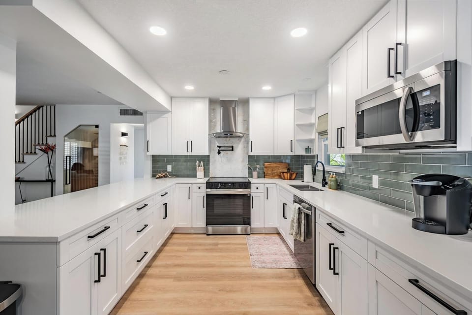 kitchen, fully stocked with appliances including coffee pot and keurig