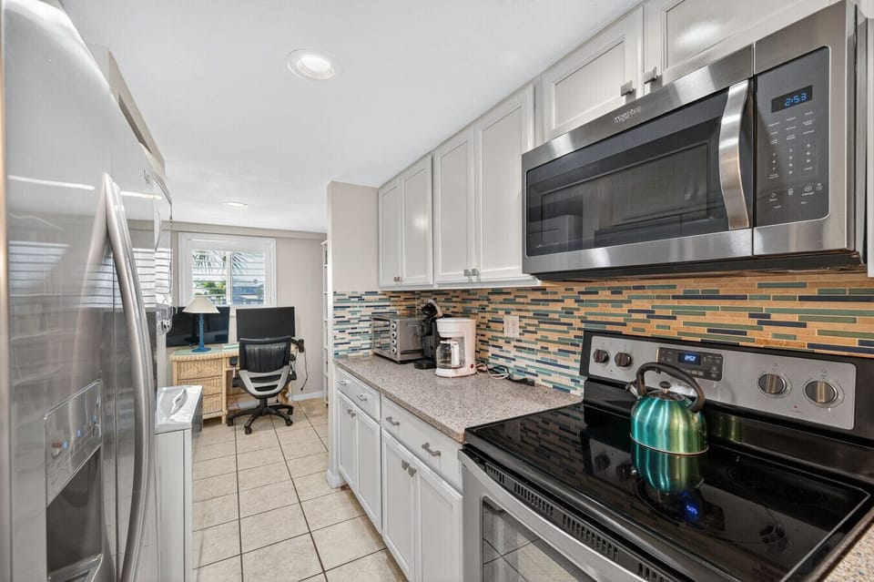 Sleek kitchen w/ stainless appliances and plenty of counter space for easy home cooking.