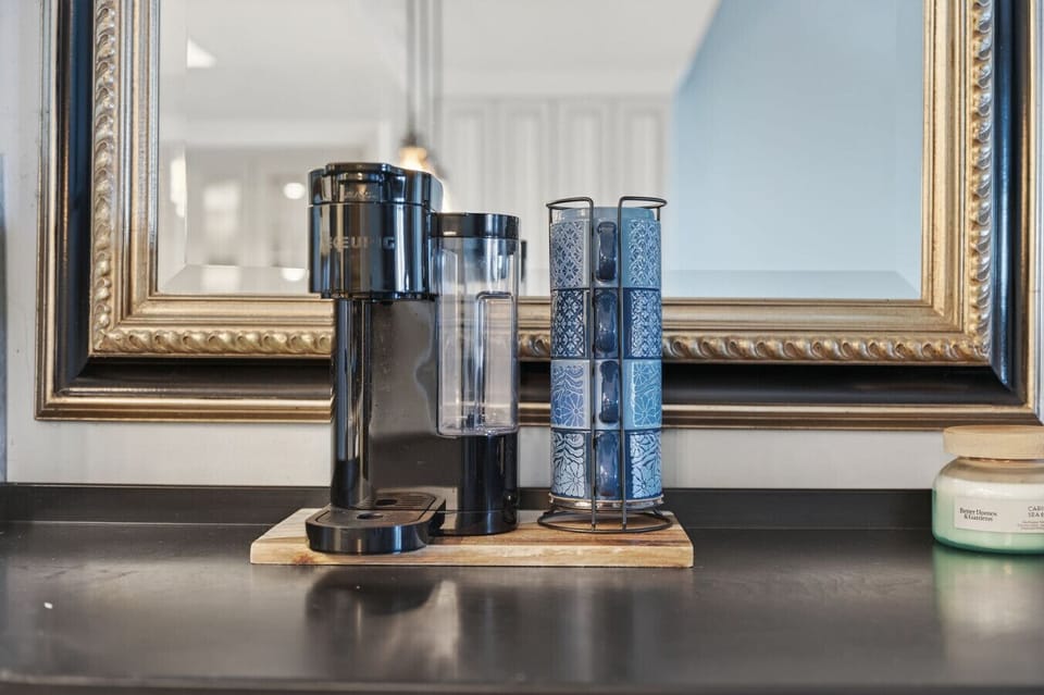 Coffee station detail w/ espresso machine & glassware, perfect for slow mornings or afternoon pick-me-ups.