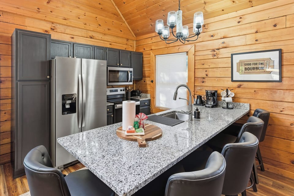 Prepare meals and gather around the stunning granite countertops in this fully equipped kitchen. Enjoy the convenience of stainless steel appliances and relax on the comfortable counter stools as you share food, laughter, and mountain memories.