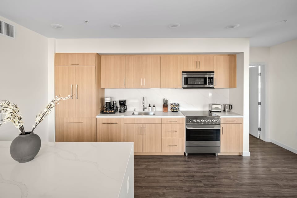 Quartz waterfall island provides seating and a perfect entertaining space.