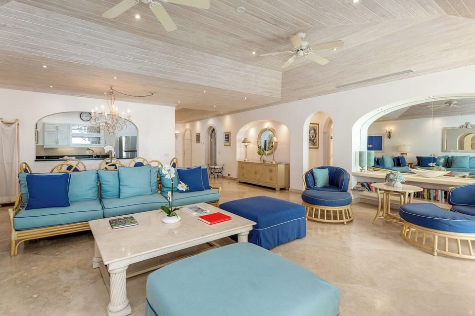 Open plan living room with comfortable sofas, chairs and a flat screen television. Perfect for relaxing and spending time with family or friends.