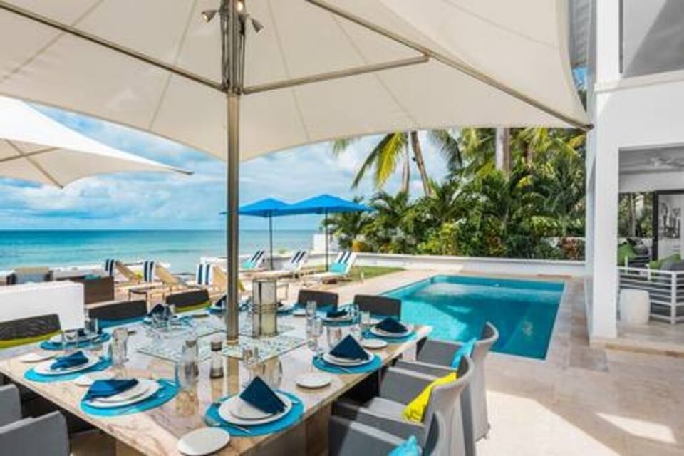 Al fresco dining area with pool and sea views