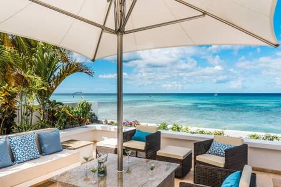 Private pool area with sun loungers, al fresco dining and sea views and direct access to the beach.