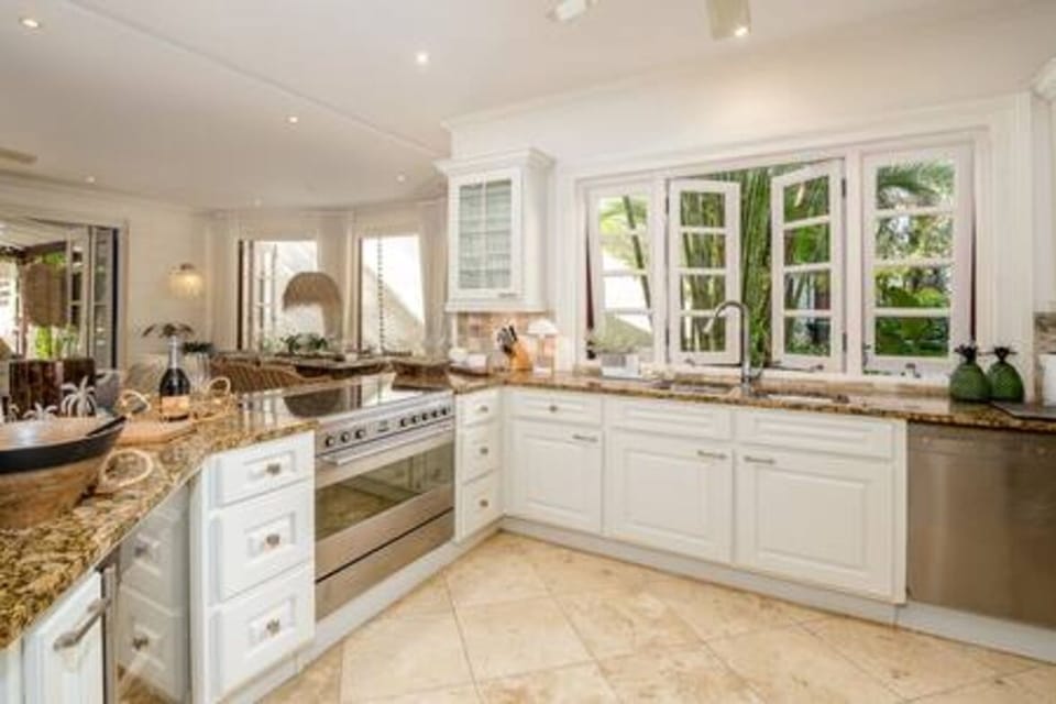 Well appointed open plan kitchen featuring a beautiful breakfast bar, blender, coffee maker, dishwasher, food processor, juicer, kettle, microwave, oven and hob.