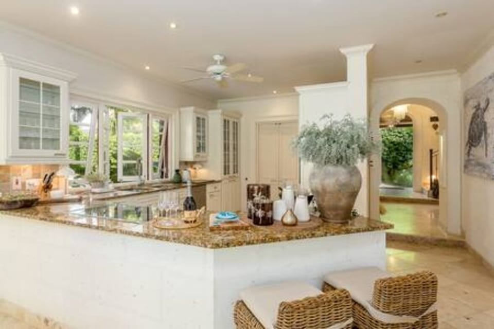 Well appointed open plan kitchen featuring a beautiful breakfast bar, blender, coffee maker, dishwasher, food processor, juicer, kettle, microwave, oven and hob.