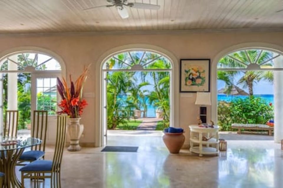 An elegant open plan space which combines a restful seating area and dining section, all with magnificent views out to the beach and sea beyond.