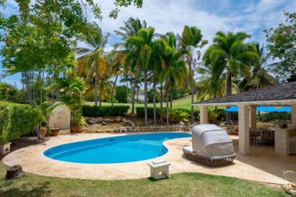 Beautiful pool area with sun beds and parasols.
