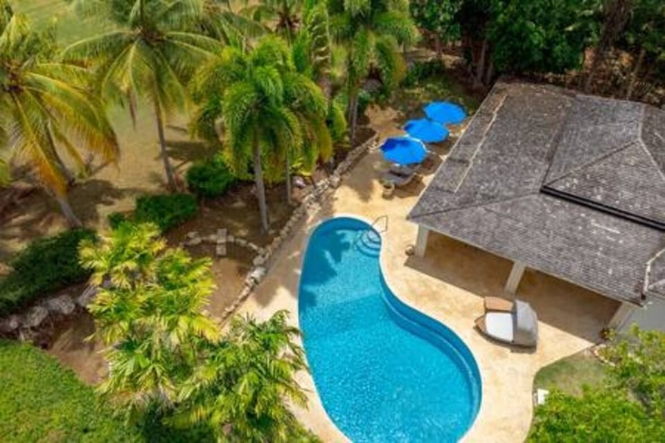 Beautiful pool area with sun beds and parasols.