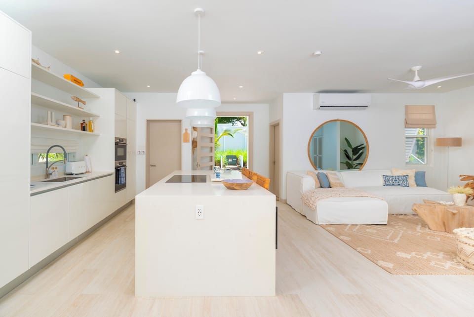 Well appointed open plan kitchen with views out to the private pool. Amenities include a blender, dishwasher, induction hob, iron and board, kettle microwave, Nespresso machine, oven, toaster, tumble dryer, washing machine and Wi-Fi throughout.