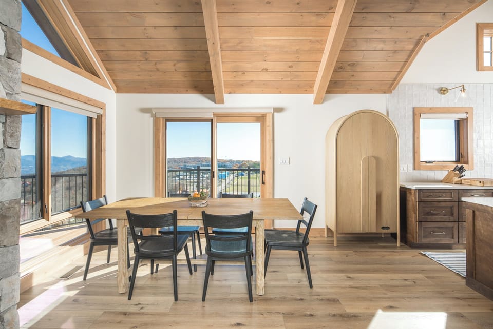 Bright dining space with mountain views and balcony access.