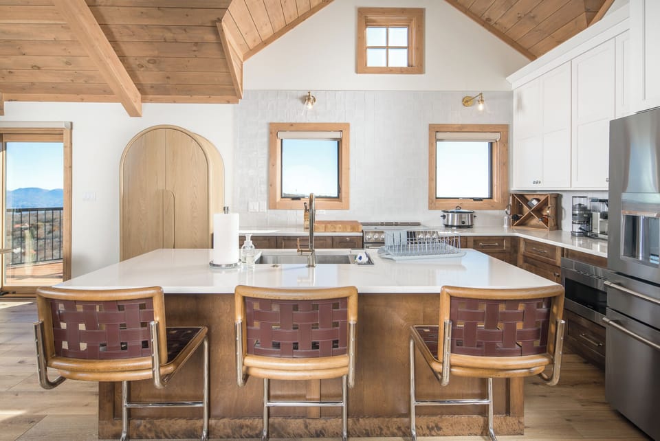 Modern kitchen with island seating and mountain views