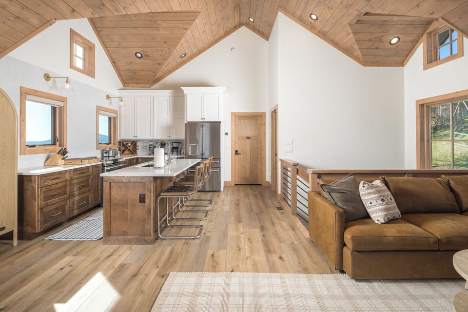 Bright open kitchen with bar seating and rustic charm.