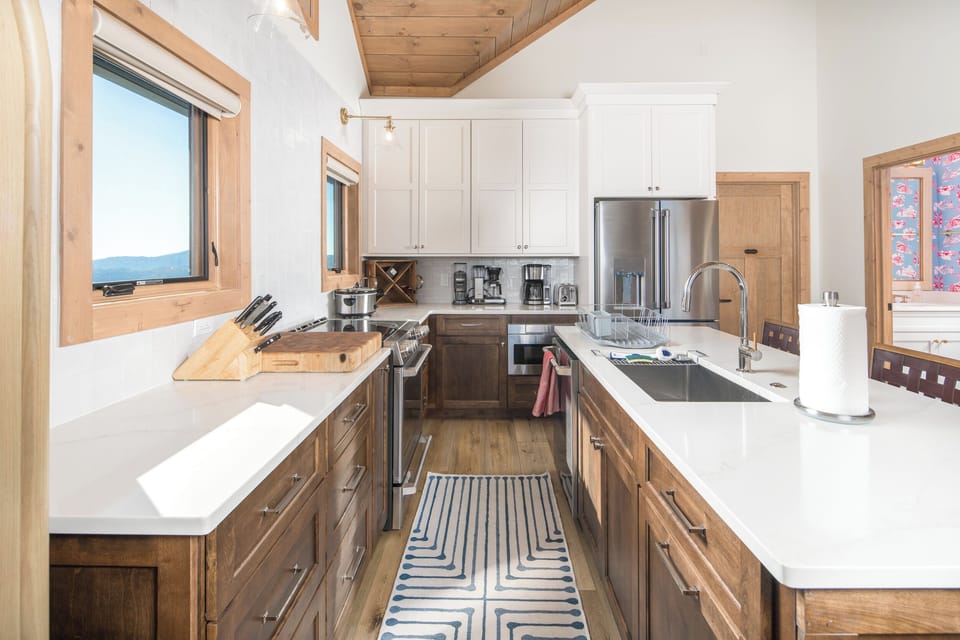 Bright kitchen with modern design and stainless appliances.