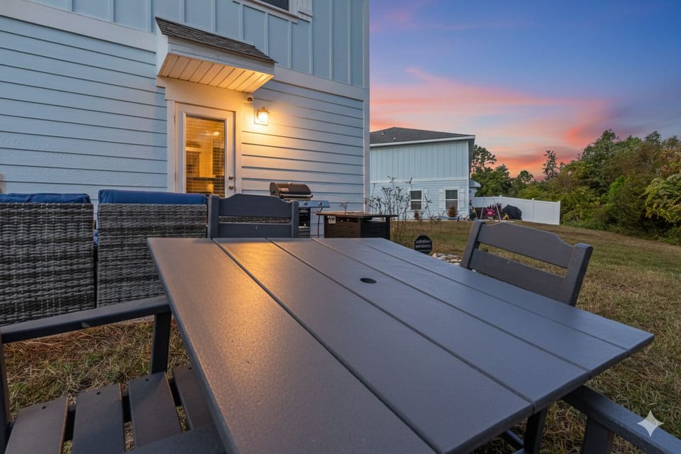 Enjoy outdoor dining in the private backyard with a spacious table and seating. 