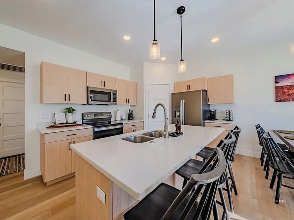 The kitchen, dining area, and living room are open and make gathering with friends and family easy