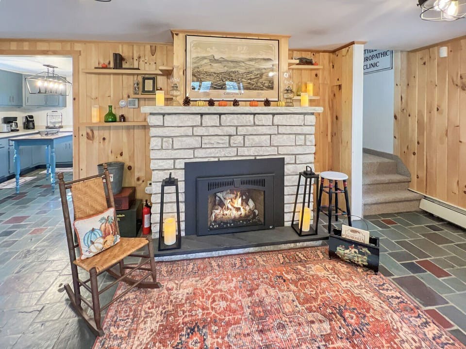 Gas fireplace with stone surround in the main living area.
