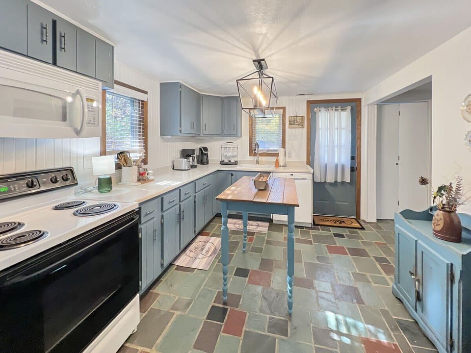 Electric stove and generous counter space for cooking.