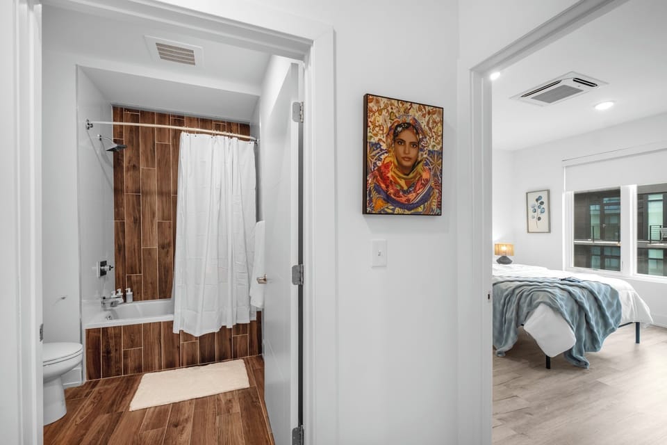 Nice clean modern bathroom with shower, jetted tub, toilet.
