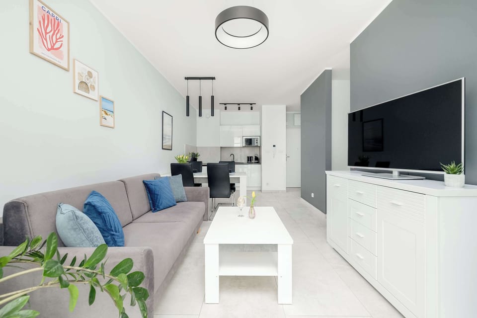 Cosy and inviting living room with a comfortable sofa, modern coffee table, and flat-screen TV — perfect for relaxing after a long day.