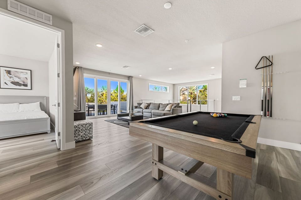 Game night just got an upgrade! Bright, modern entertainment space with sleek flooring and plenty of natural light—perfect for fun and relaxation.