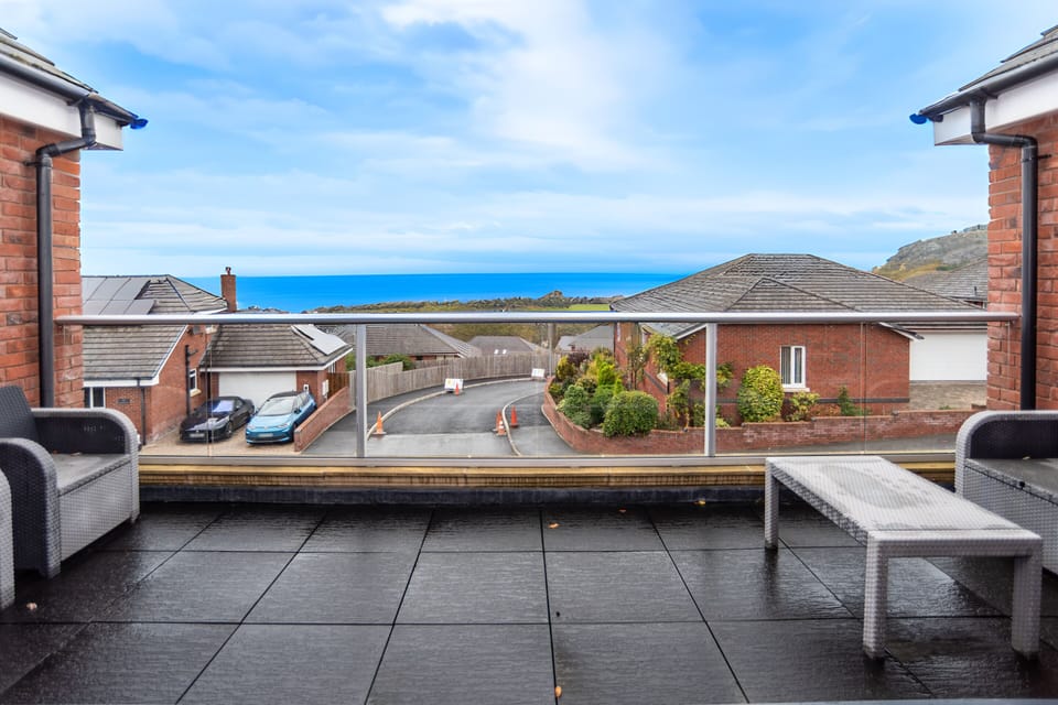 Large balcony with relaxed seating and sweeping sea views, perfect for slow mornings and sunset unwinding.