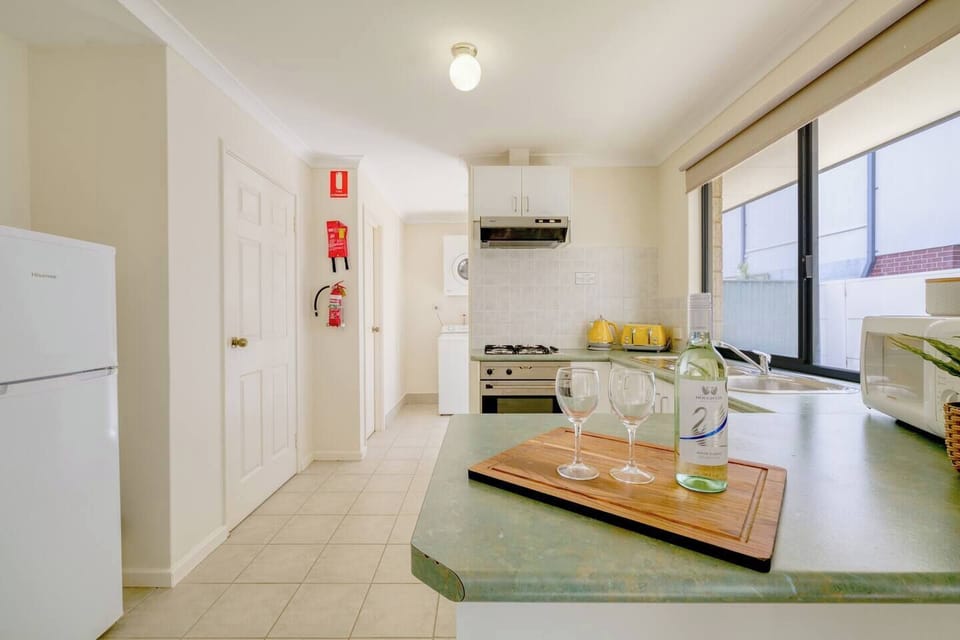 The kitchen is equipped for all your cooking needs, and fitted with a fridge, stove, oven, microwave, kettle and toaster.
