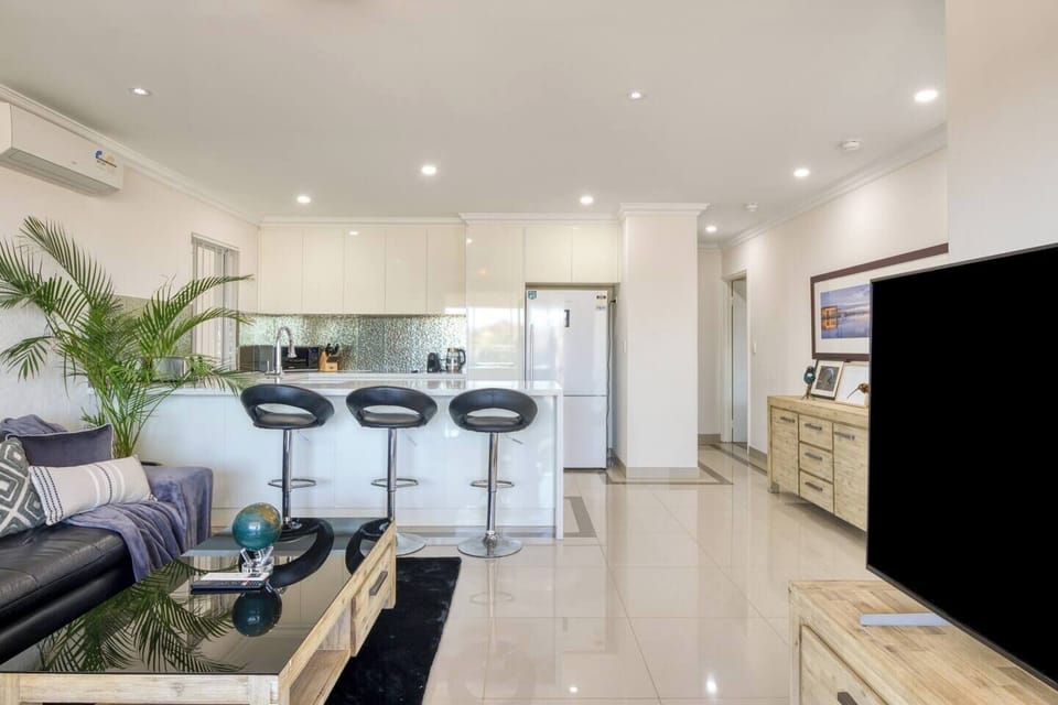 Embrace the seamless connection between the living room and kitchen, creating a sophisticated and cohesive living space.