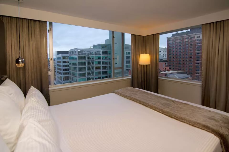 Wake up to sweeping city views from a cloud-soft bed.