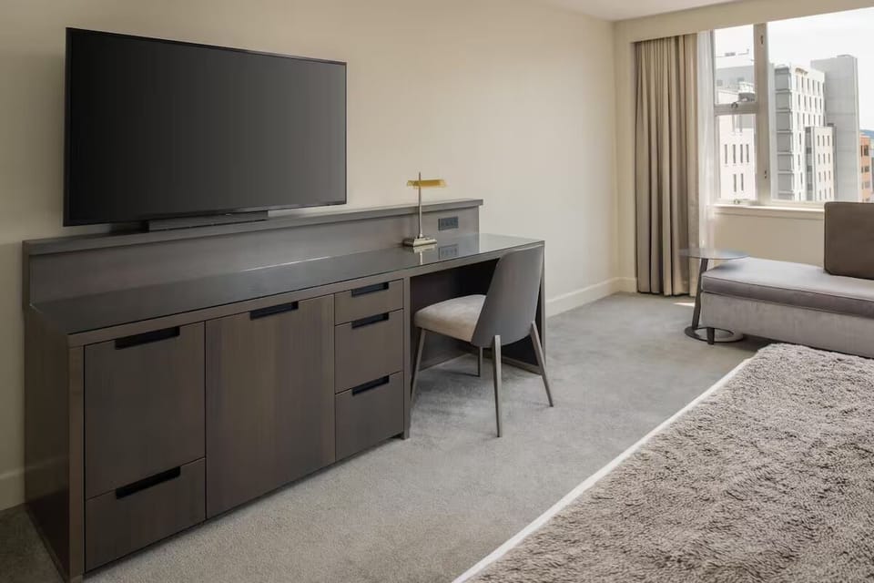 Catch up on work at the sleek desk and large TV.