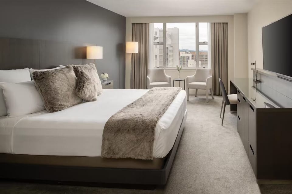 Unwind in a bright king room with soothing city views.