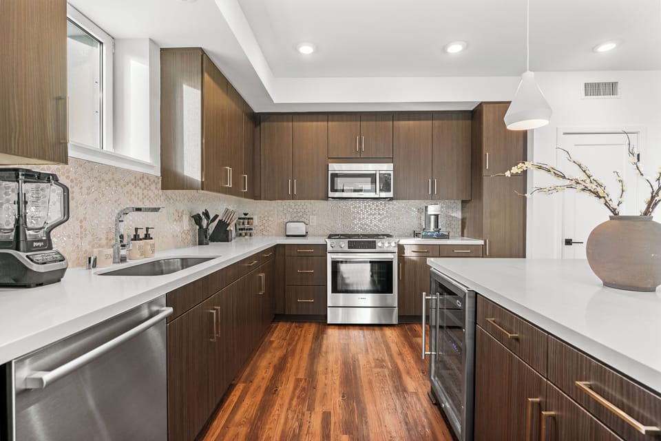 Gourmet kitchen with stainless steel appliances and a designer tile backsplash