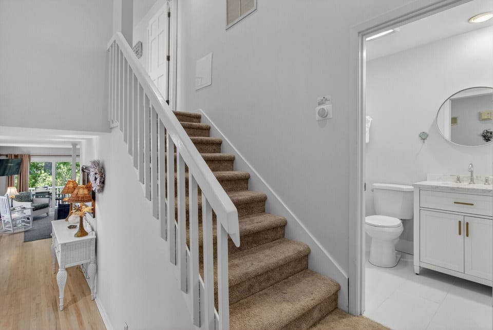 You'll appreciate the bright, airy layout connecting your private powder room to the welcoming living spaces upstairs.