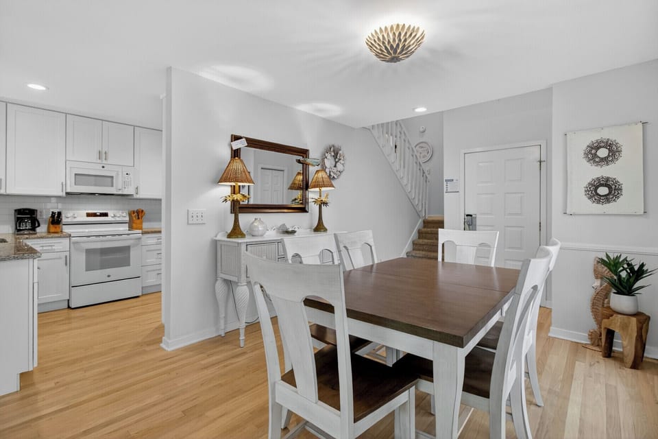 Gather around your spacious dining table for memorable meals, perfectly positioned between the well-equipped kitchen and cozy living spaces.