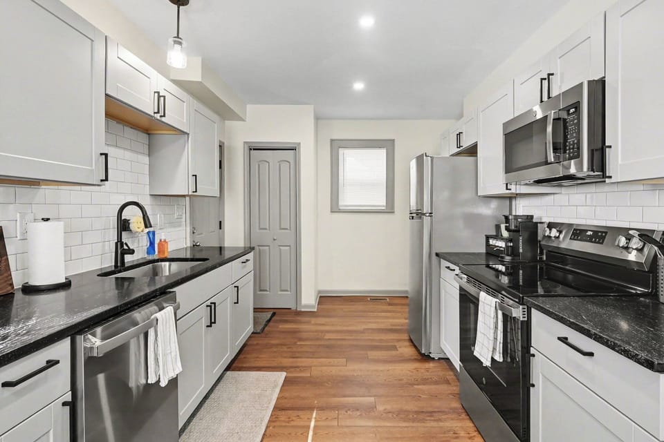 Bright galley kitchen fully equipped for cooking at home