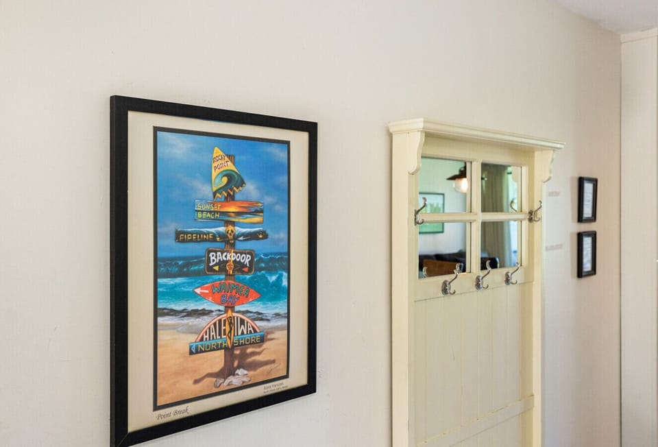 Bright hallway accented w/ coastal art welcoming you inside.