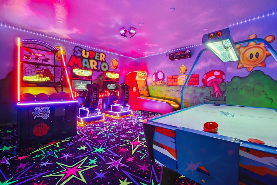 Free play in-home arcade with basketball, skee-ball, air hockey, and racing